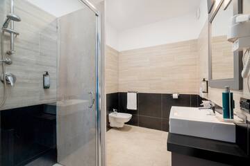 a bathroom with a shower and sink