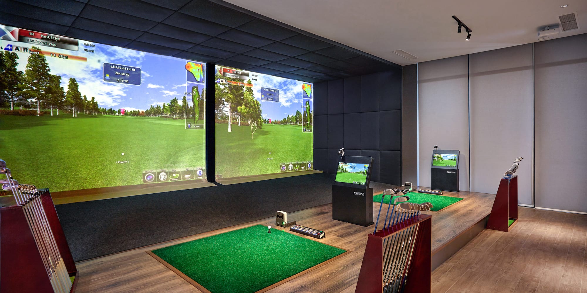a room with a golf course and a large screen