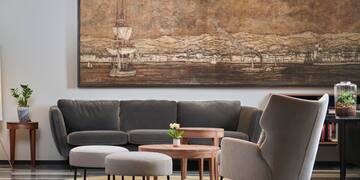 a living room with a large painting on the wall