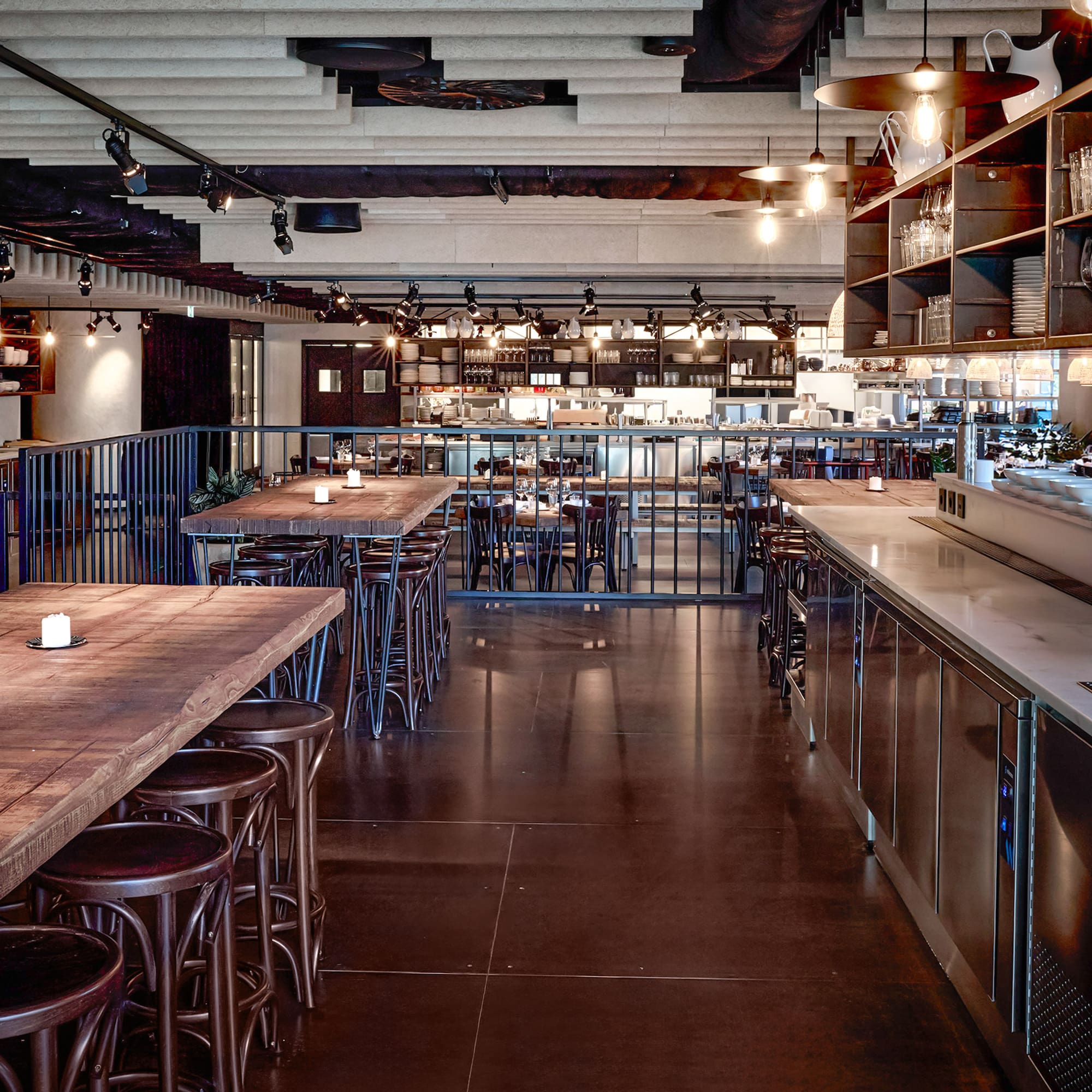 a large room with tables and stools