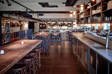 a large room with tables and stools