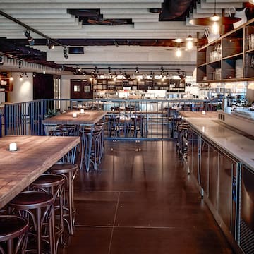 a large room with tables and stools