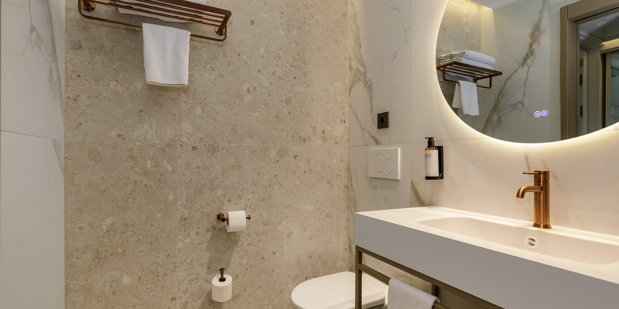 a bathroom with a round mirror and a sink