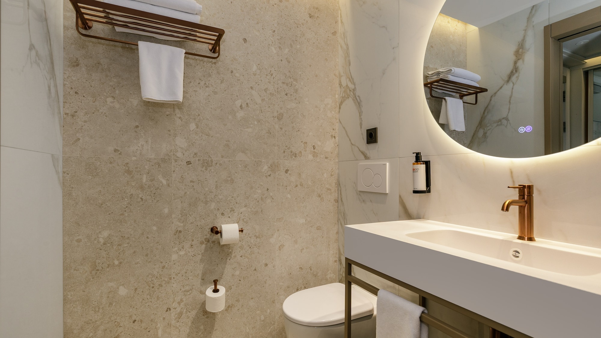 a bathroom with a round mirror and a sink