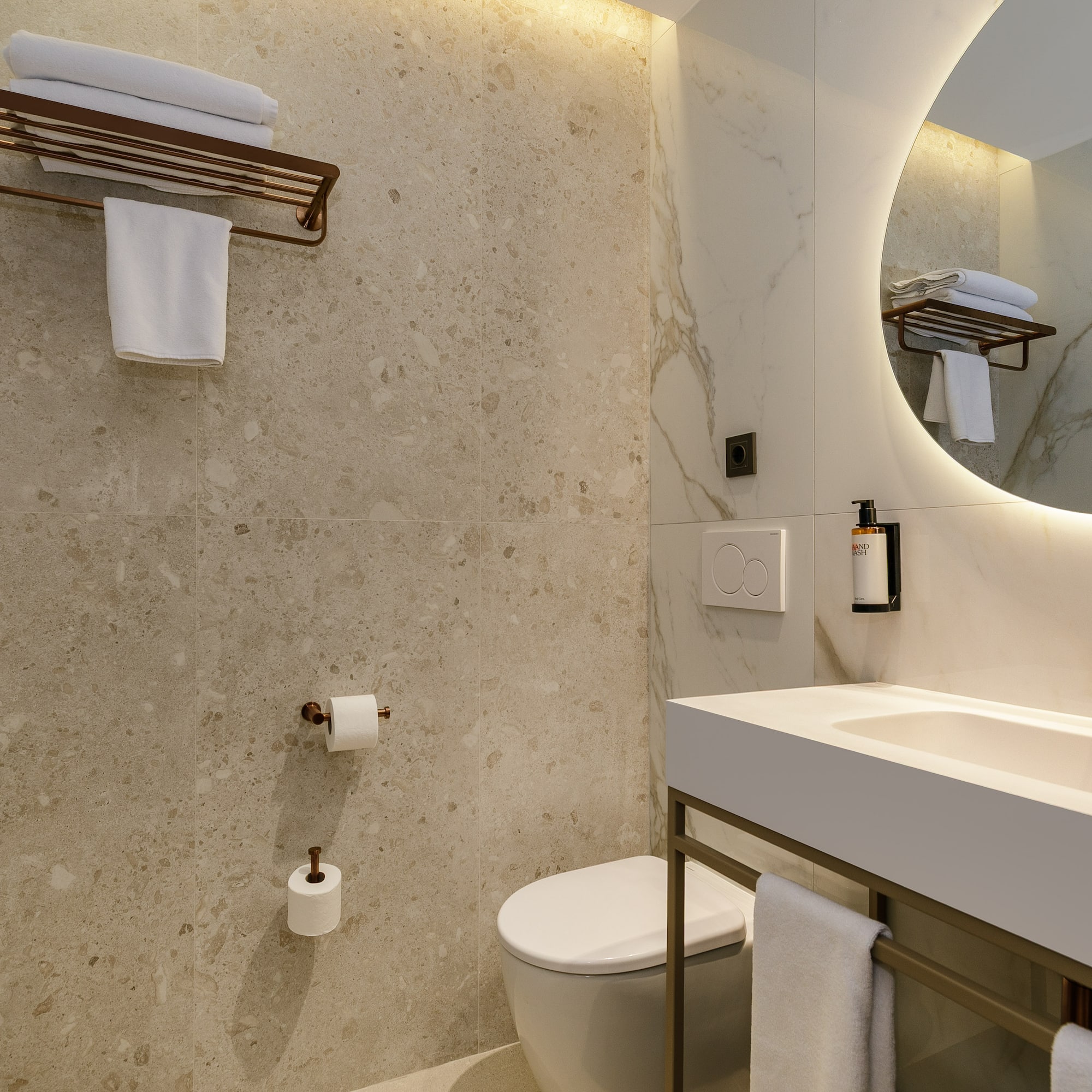 a bathroom with a round mirror and a sink