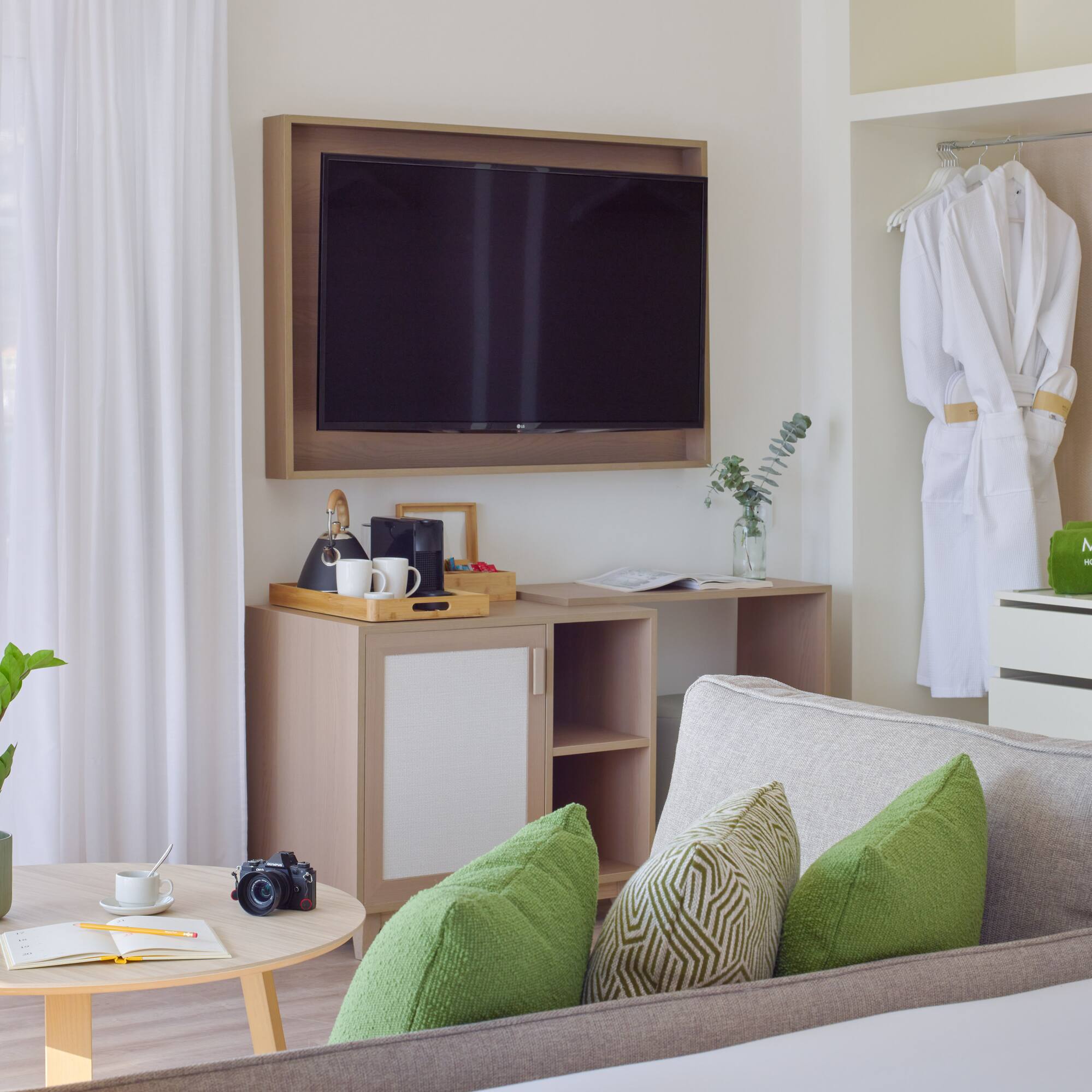 a room with a television and a white robe