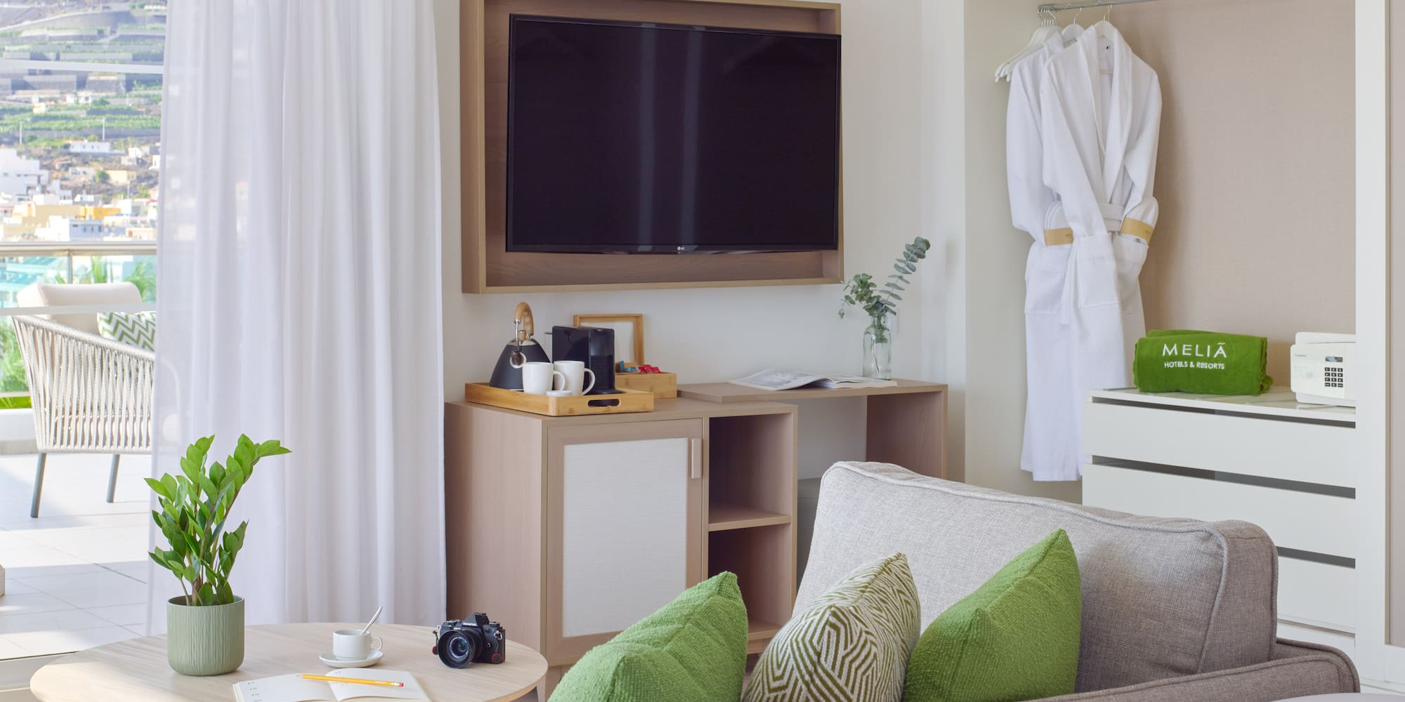 a room with a television and a white robe