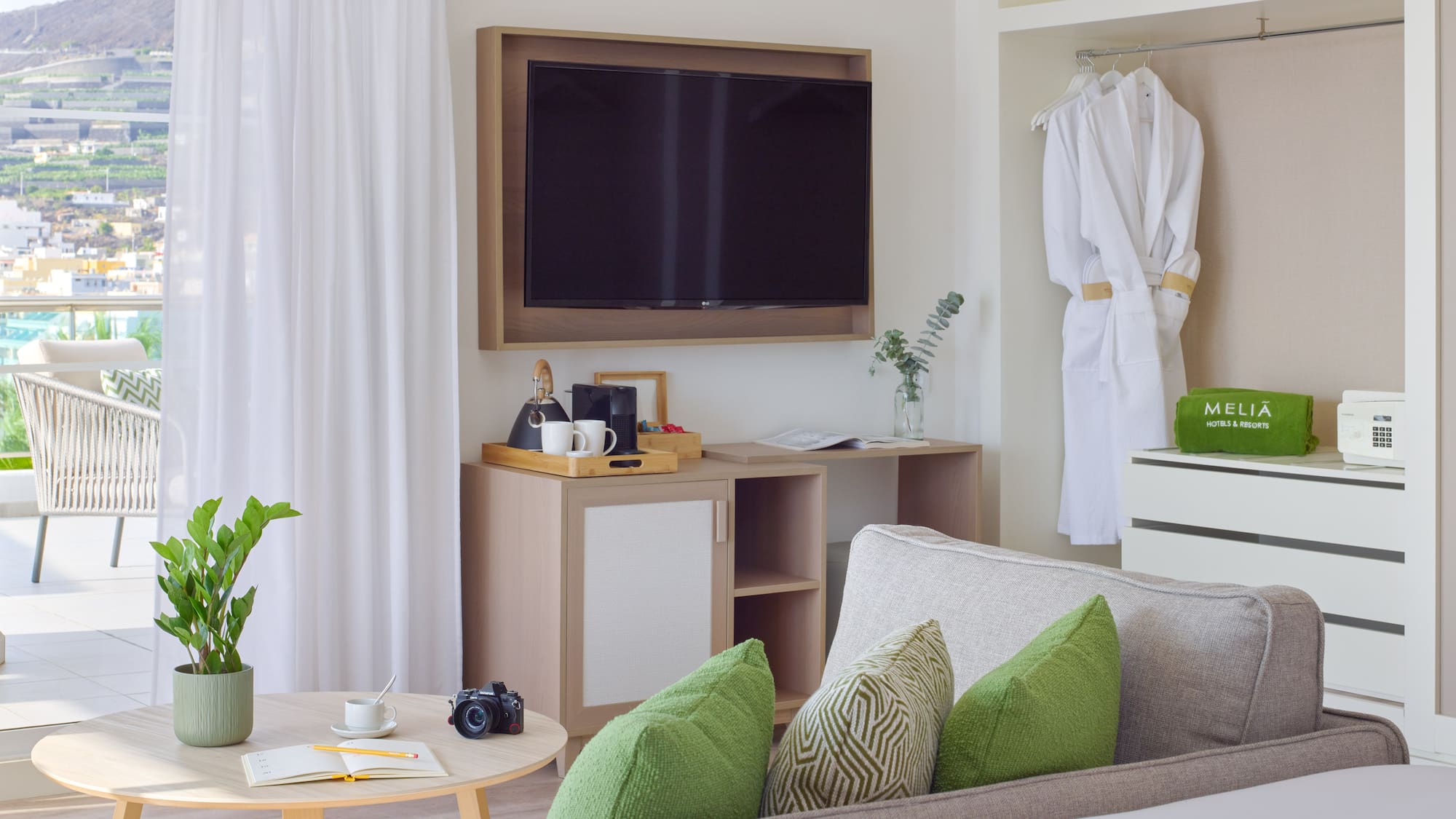 a room with a television and a white robe