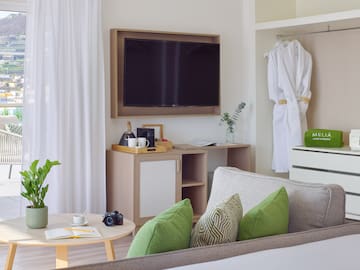 a room with a television and a white robe