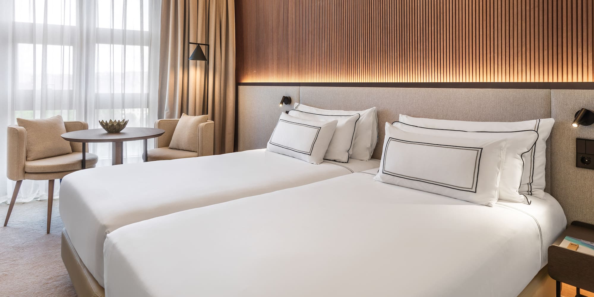 a room with two beds and a table