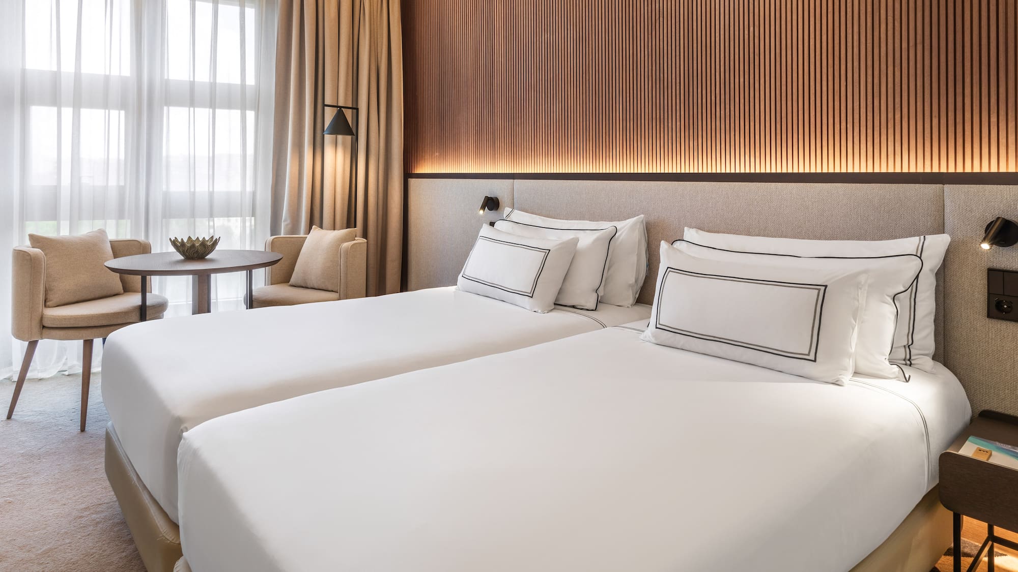 a room with two beds and a table