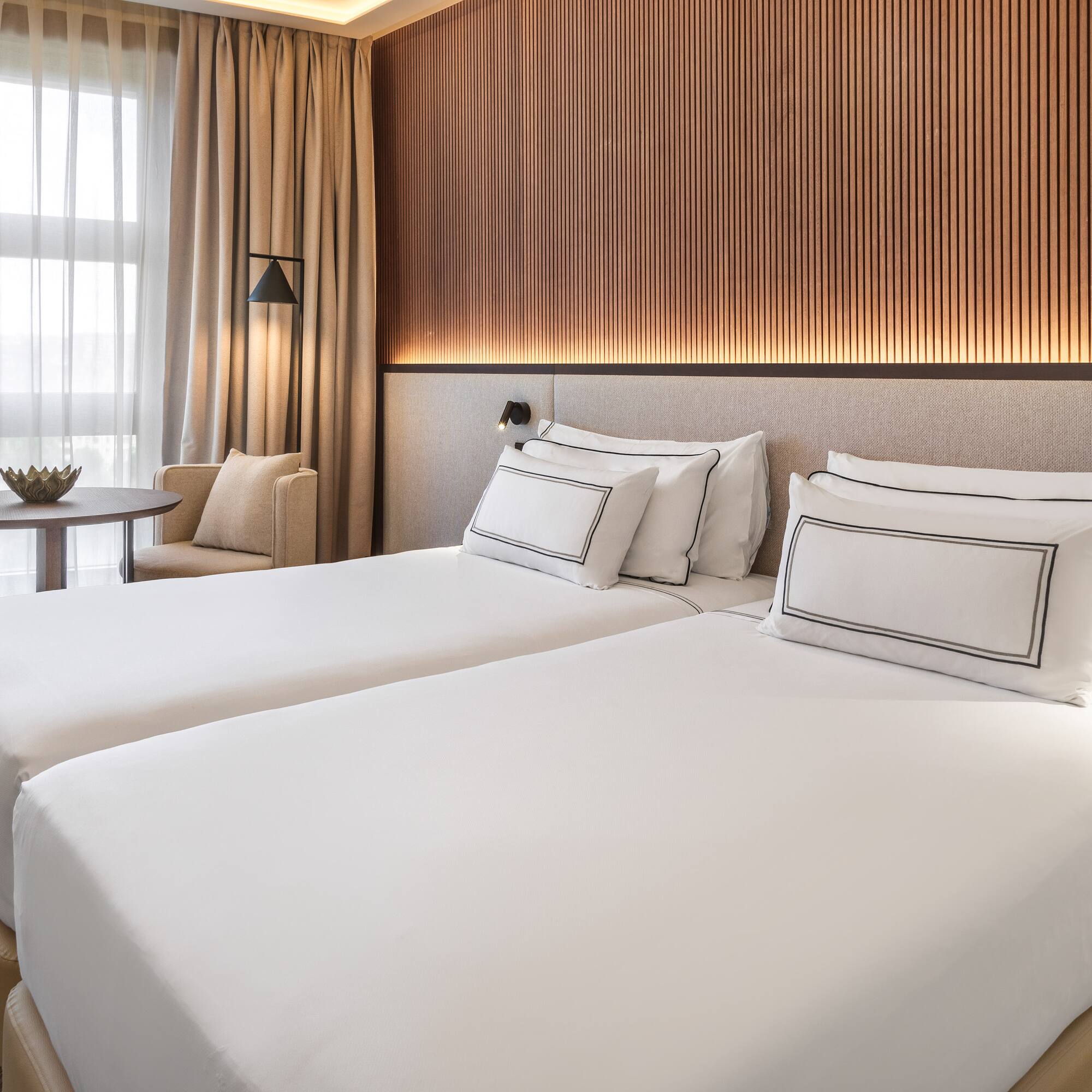 a room with two beds and a table