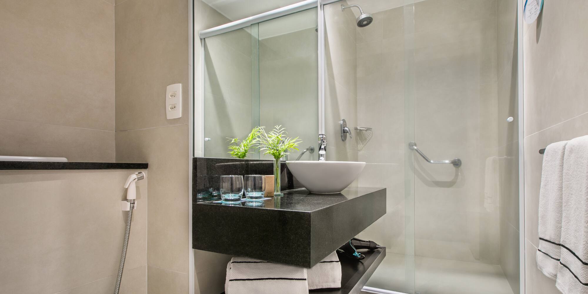 a bathroom with a glass shower and sink