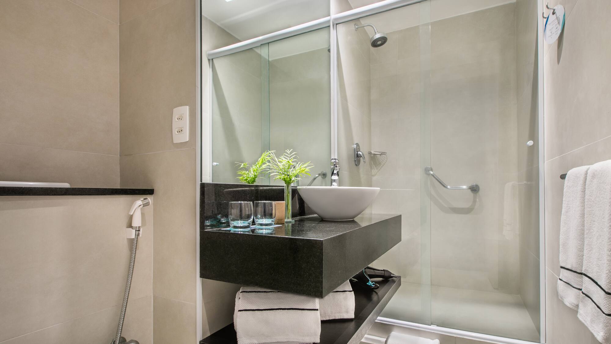 a bathroom with a glass shower and sink