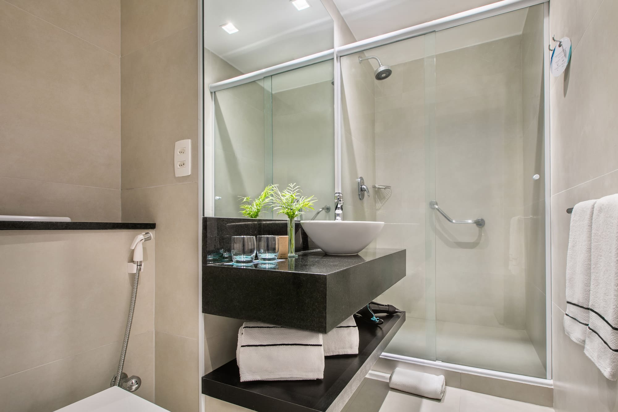 a bathroom with a glass shower and sink