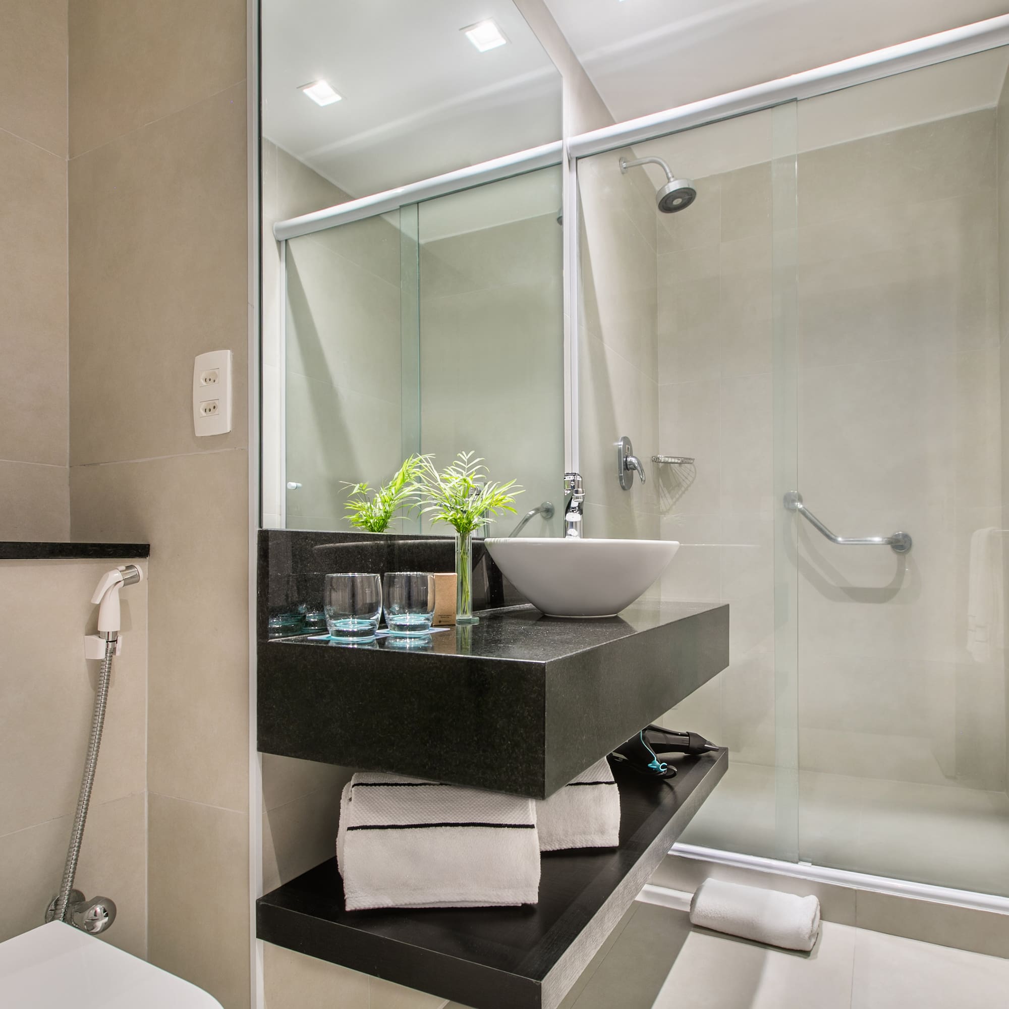 a bathroom with a glass shower and sink