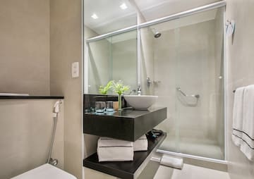 a bathroom with a glass shower and sink