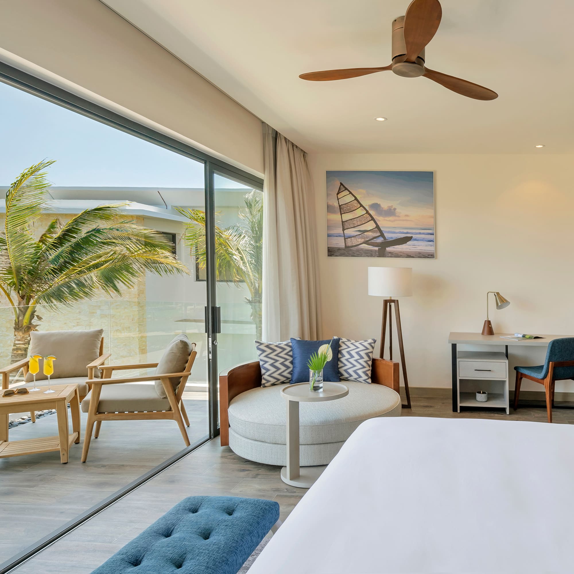 a room with a bed and chairs and a table