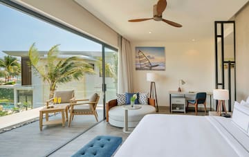 a room with a bed and chairs and a table