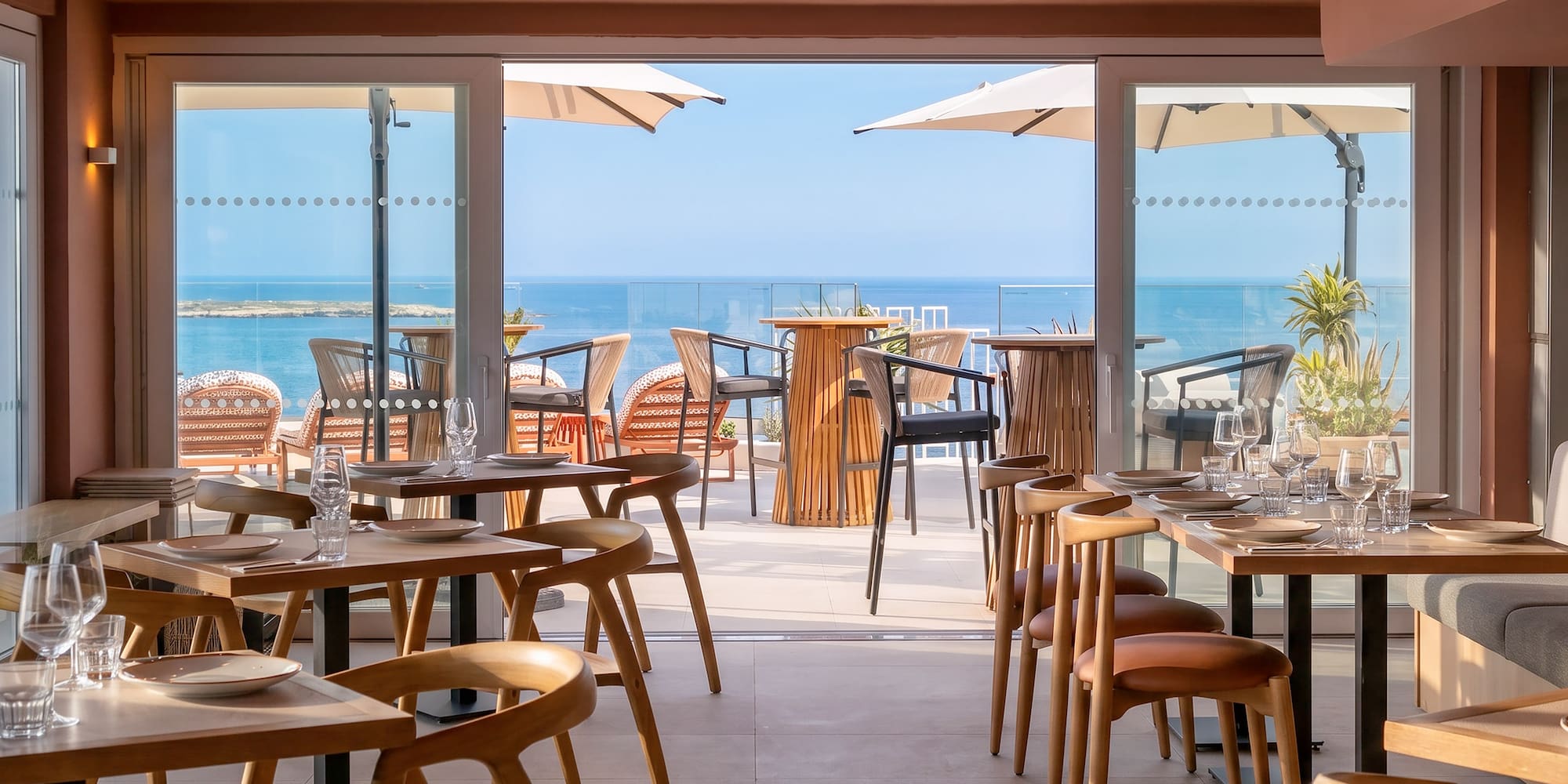 Coastal restaurant with stylish indoor dining and ocean-view terrace.