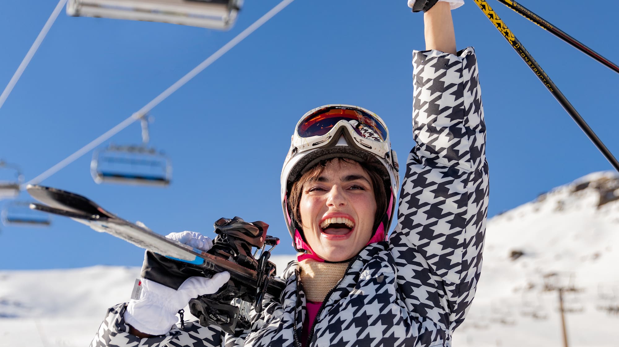 a woman holding ski poles and smiling