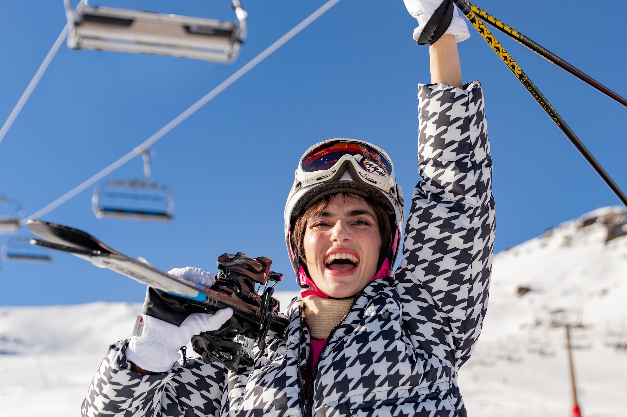 a woman holding ski poles and smiling