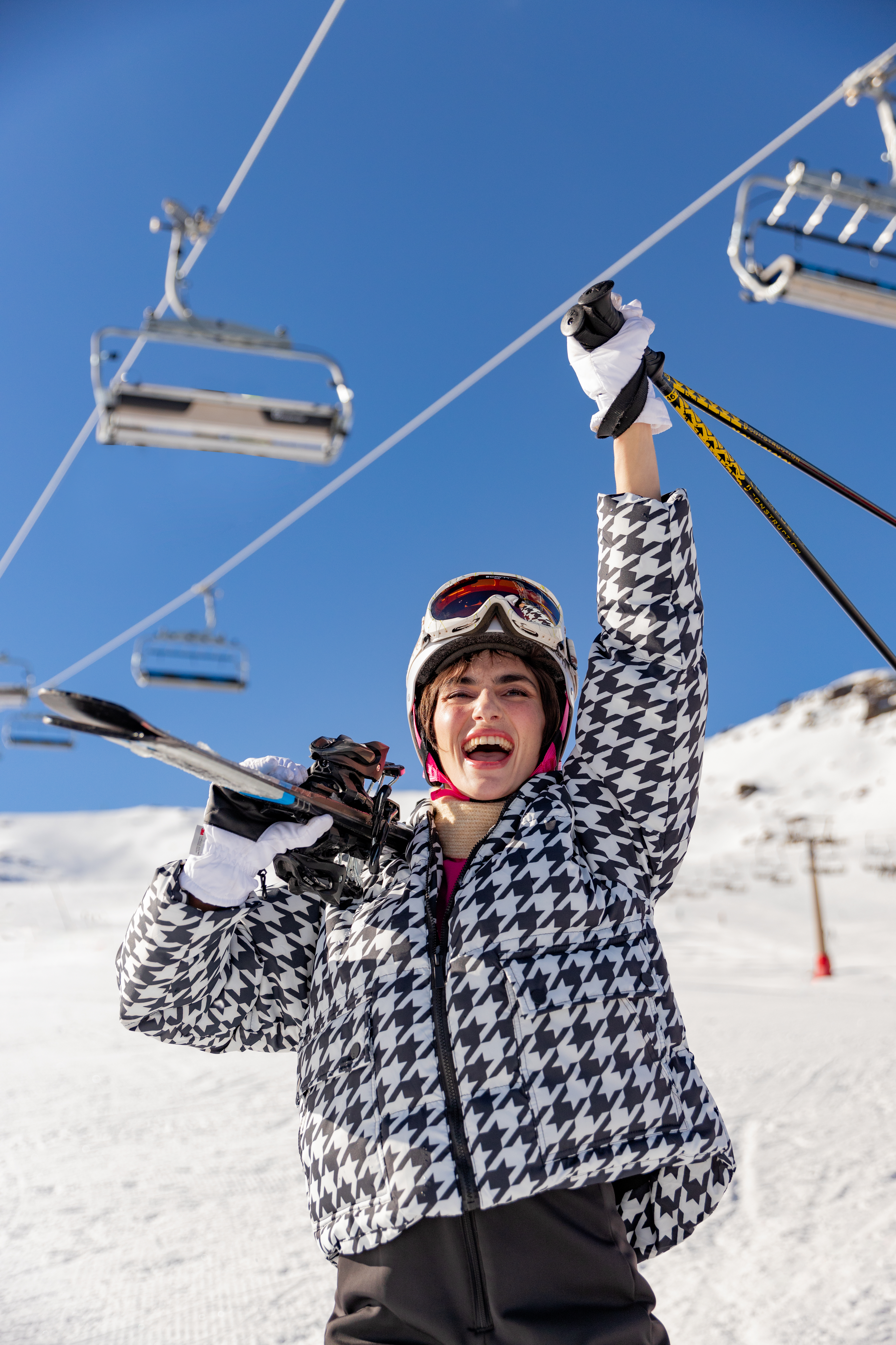 a woman holding ski poles and smiling