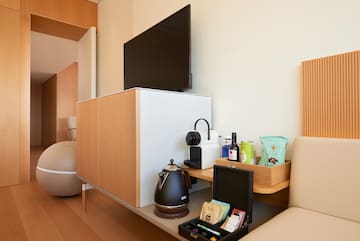 a room with a tv and coffee pot