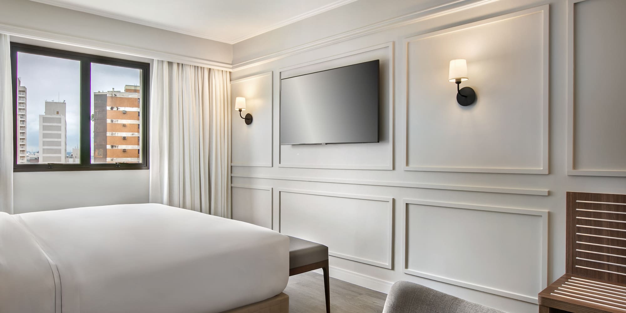 a room with a bed and a television on the wall