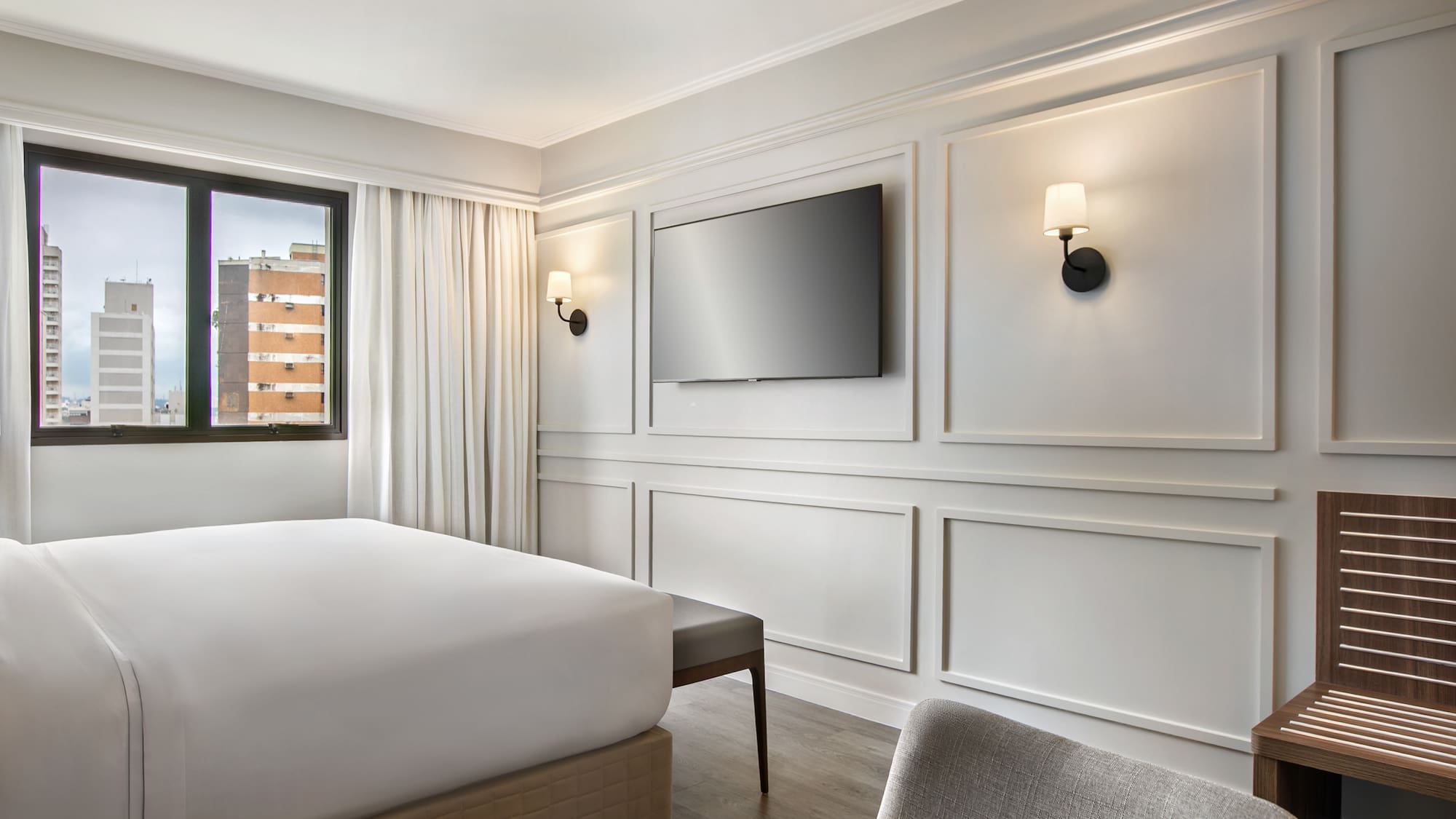 a room with a bed and a television on the wall