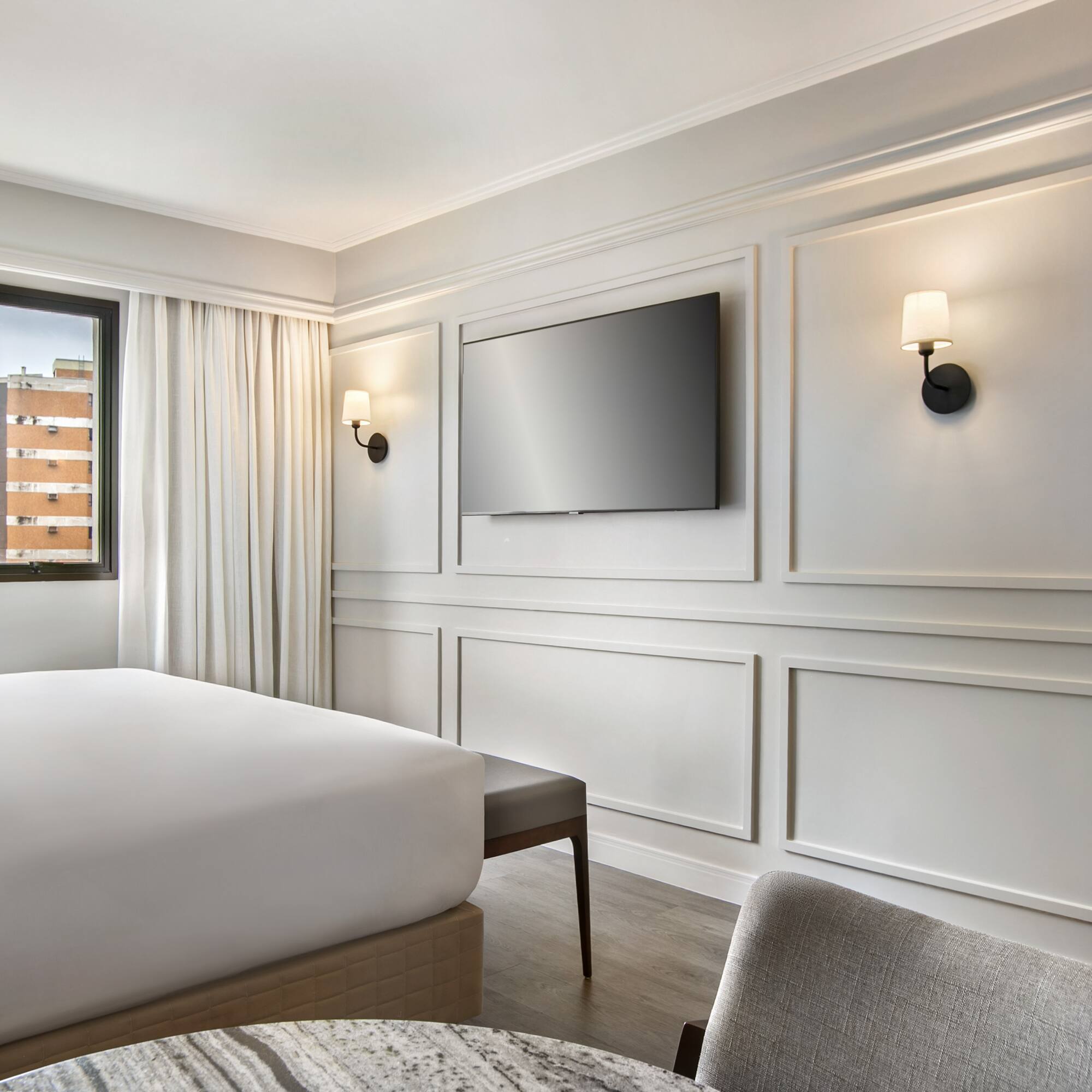 a room with a bed and a television on the wall