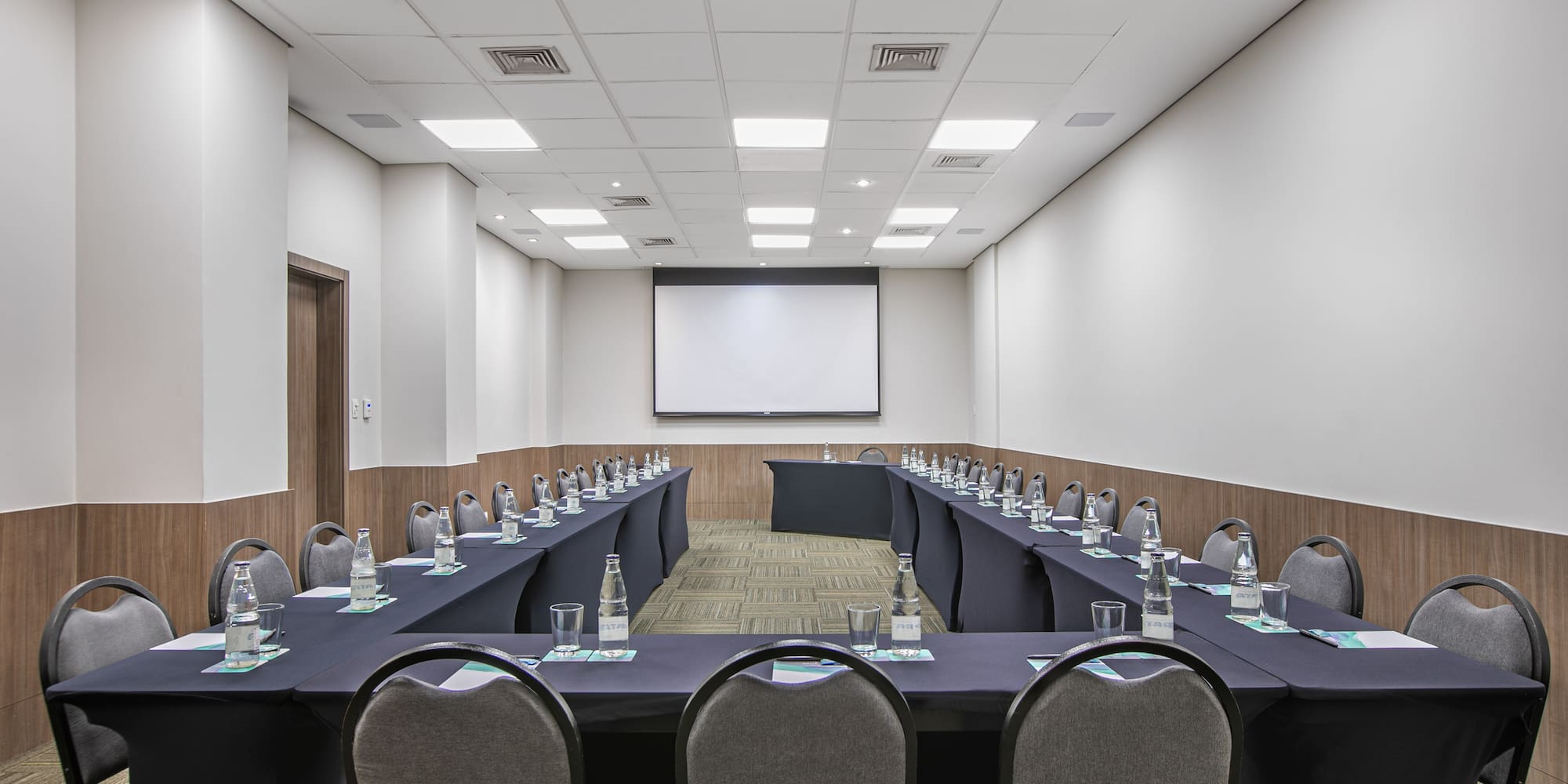 a room with long tables and chairs