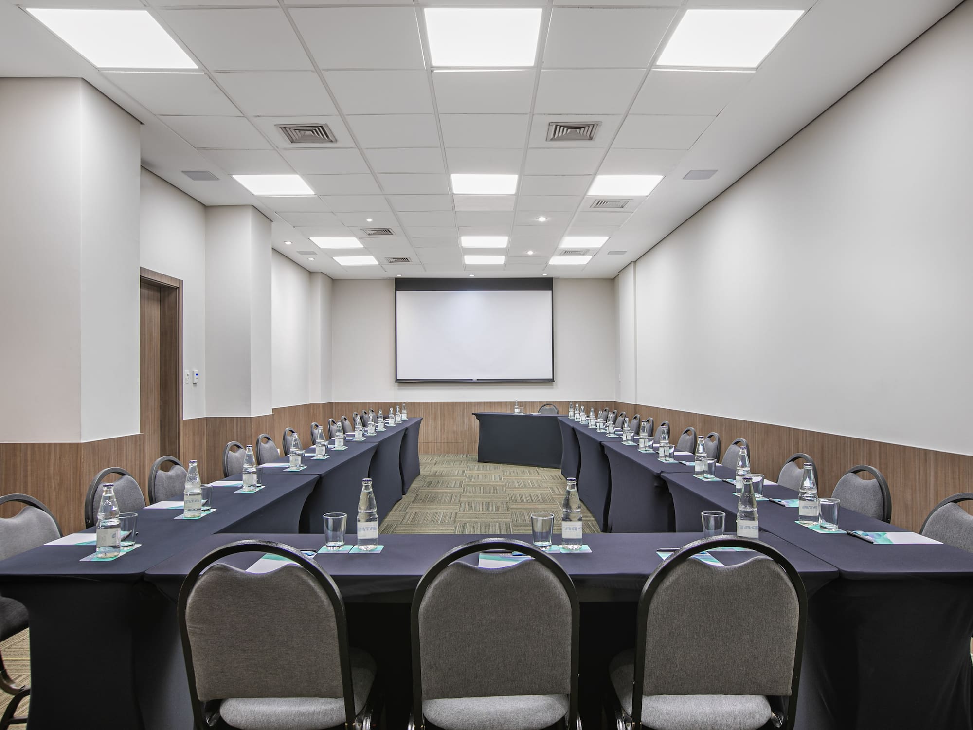 a room with long tables and chairs