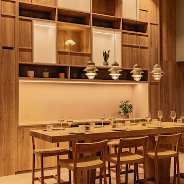 a table with chairs and glasses in a room
