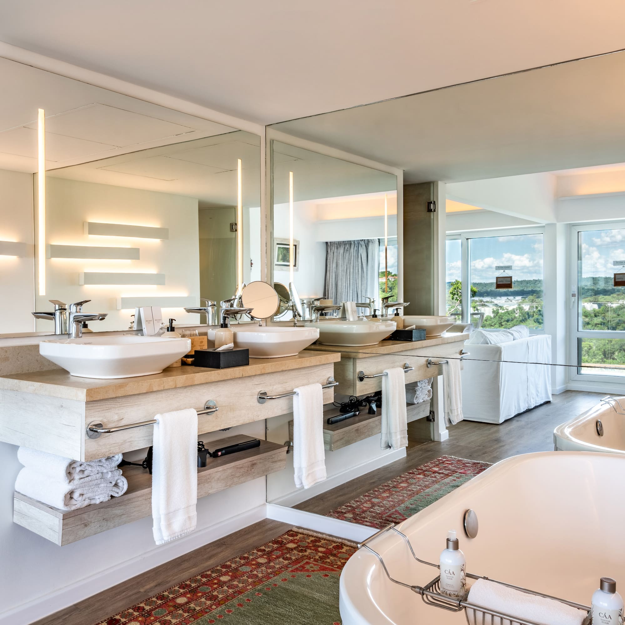a bathroom with a large mirror and a tub