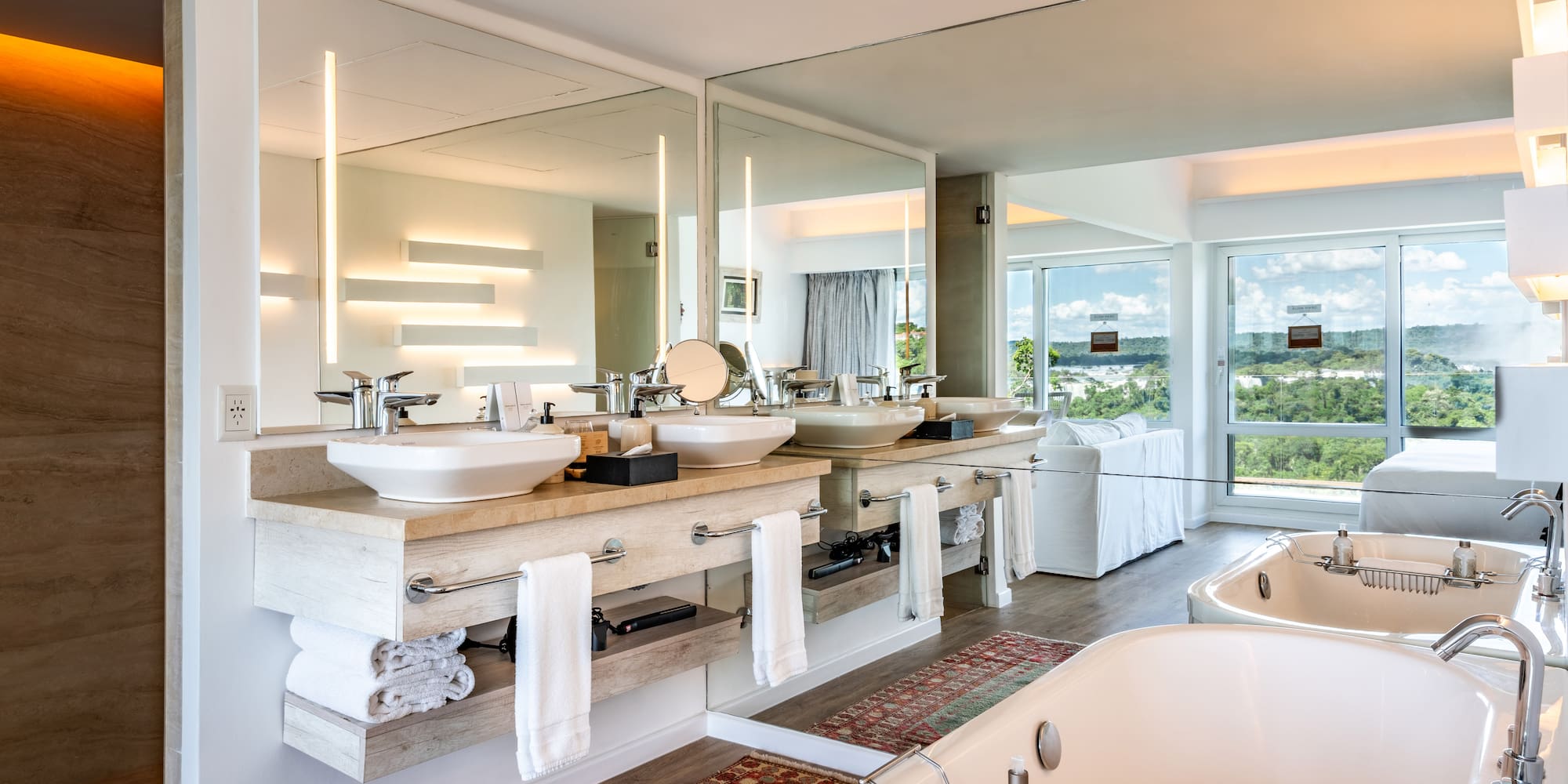 a bathroom with a large mirror and a tub