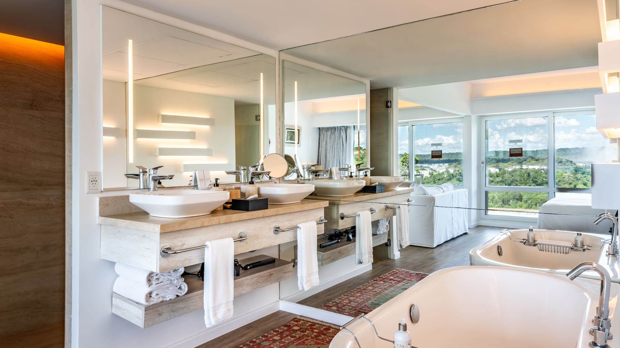a bathroom with a large mirror and a tub