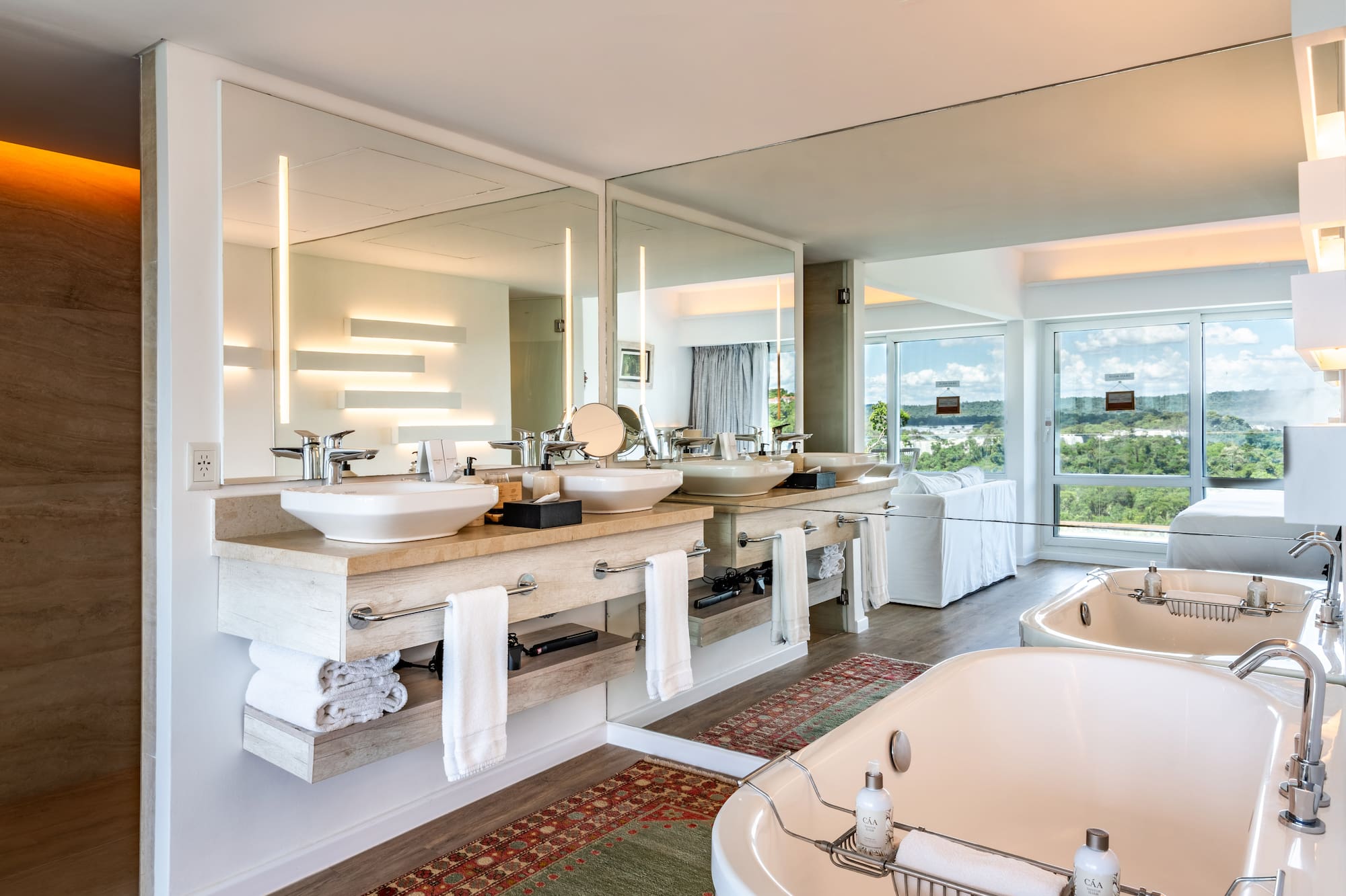 a bathroom with a large mirror and a tub