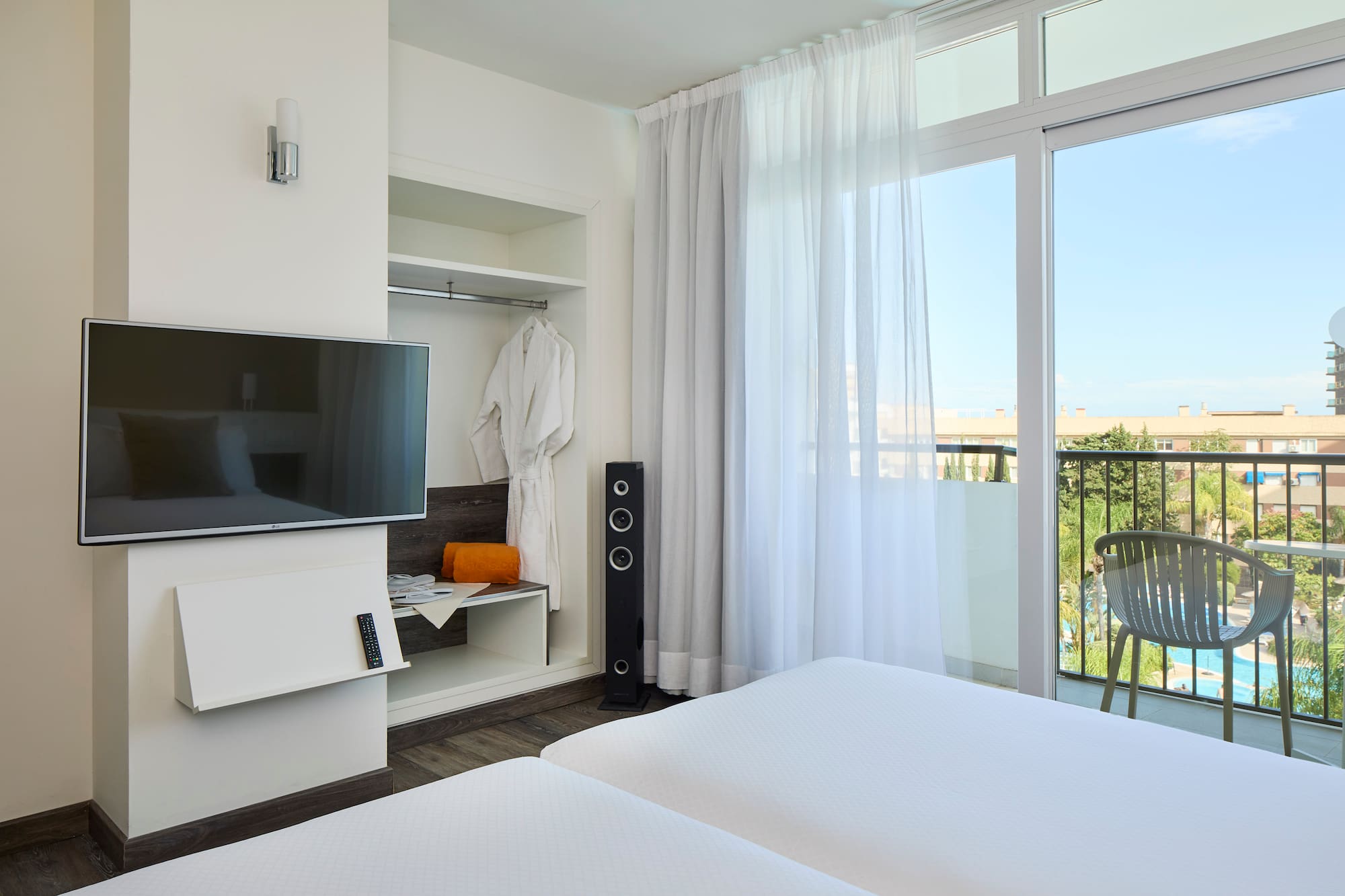 a room with a television and a balcony