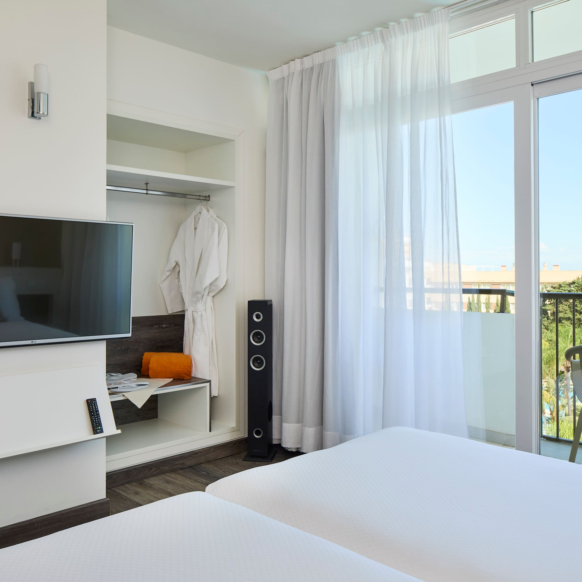 a room with a television and a balcony