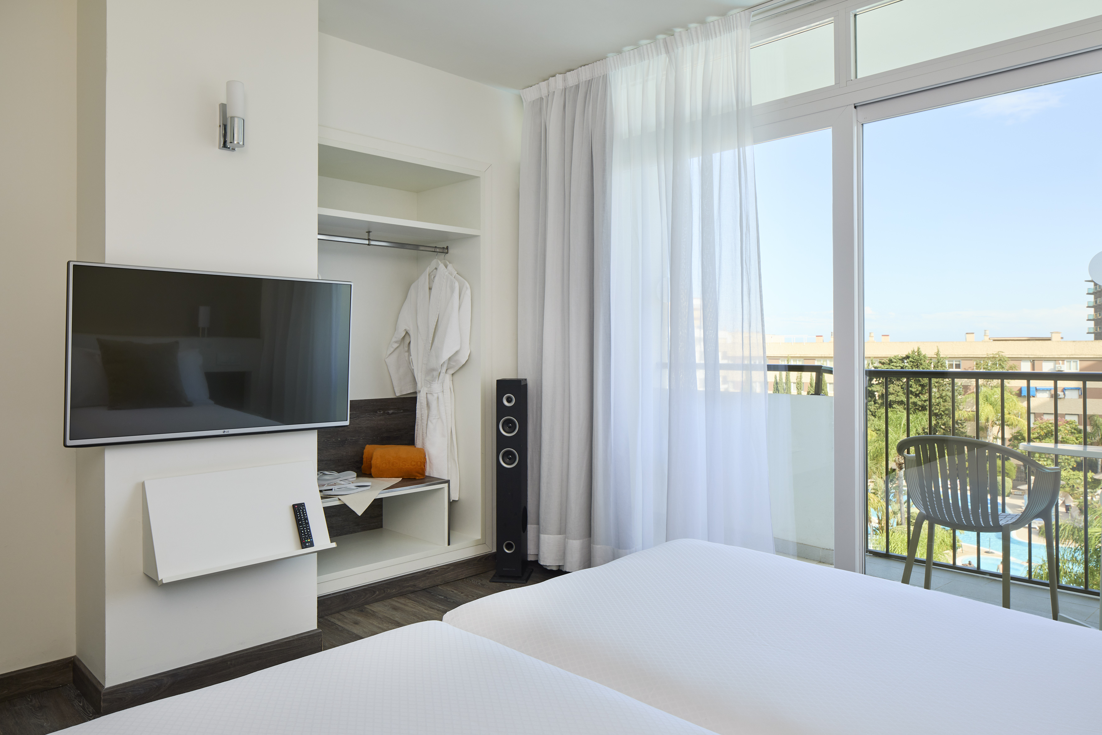 a room with a television and a balcony