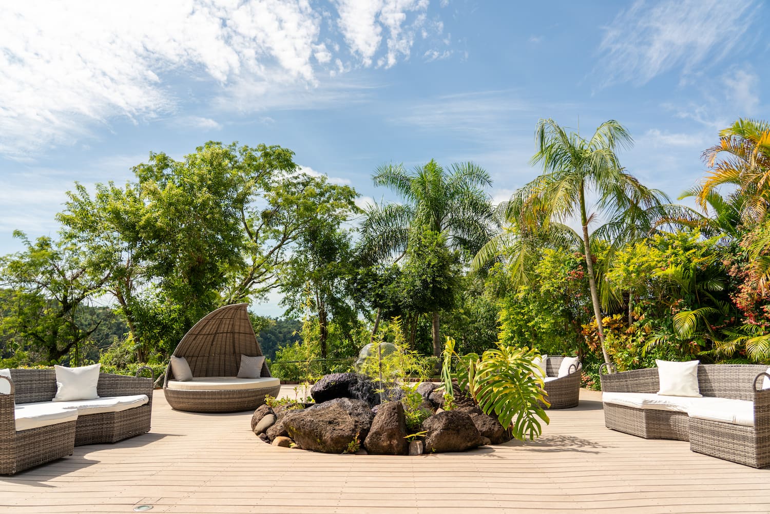 a patio with a fire pit and chairs