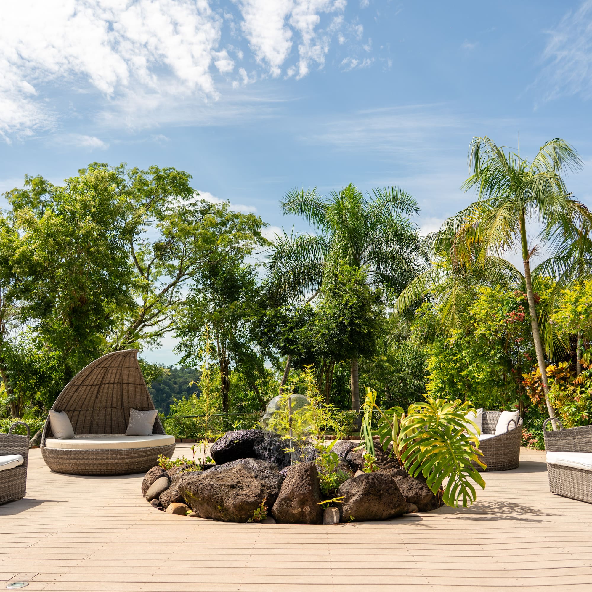 a patio with a fire pit and chairs