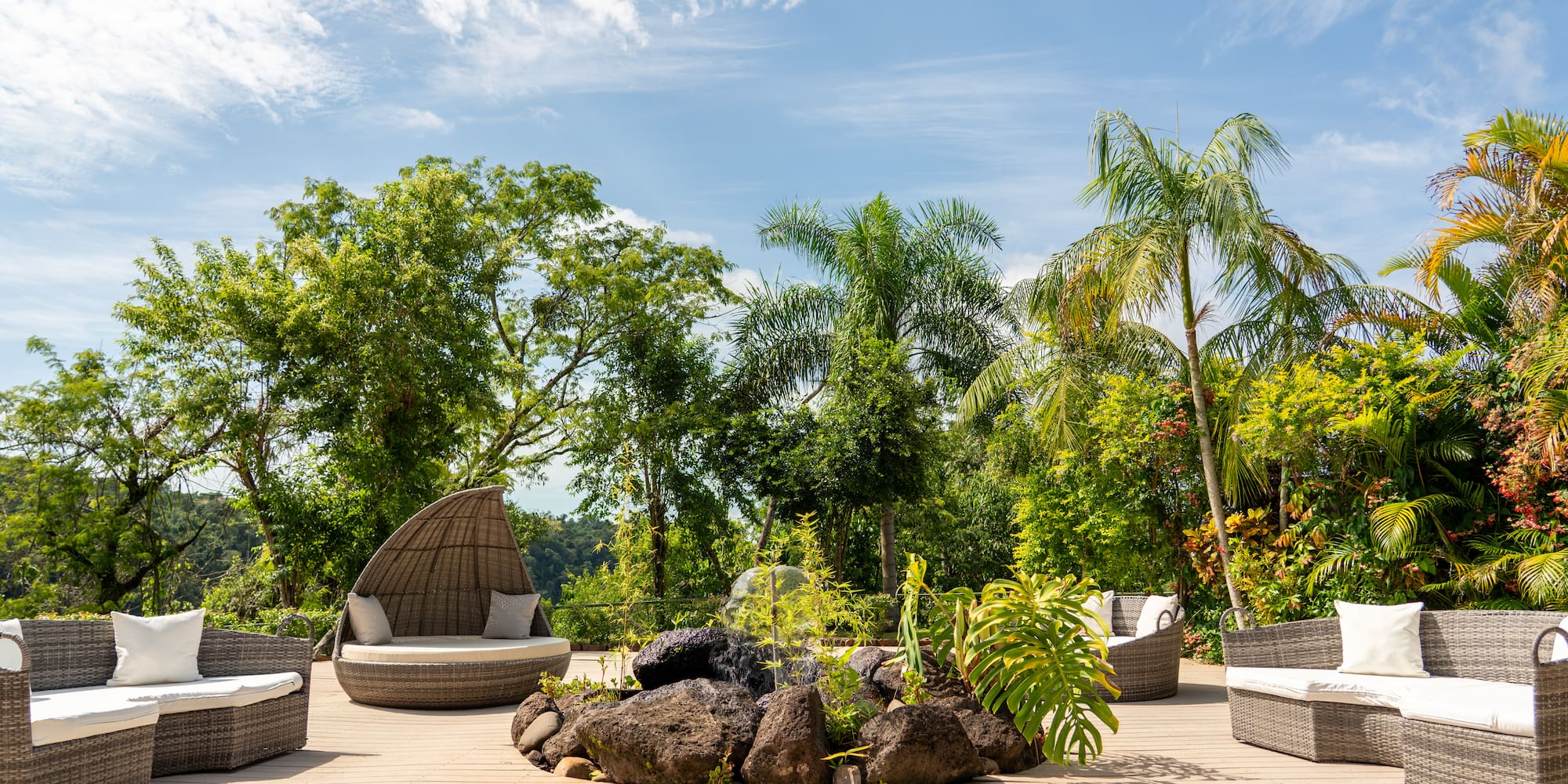 a patio with a fire pit and chairs