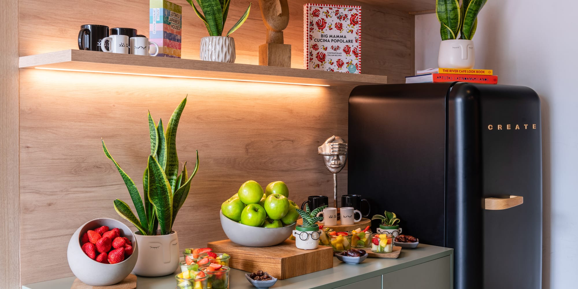 a kitchen with a black refrigerator and a black refrigerator