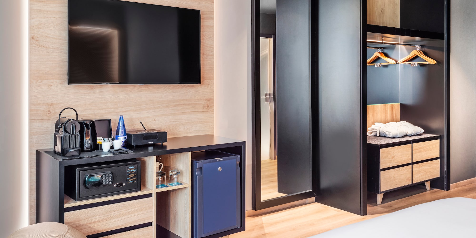 a room with a television and a mirror