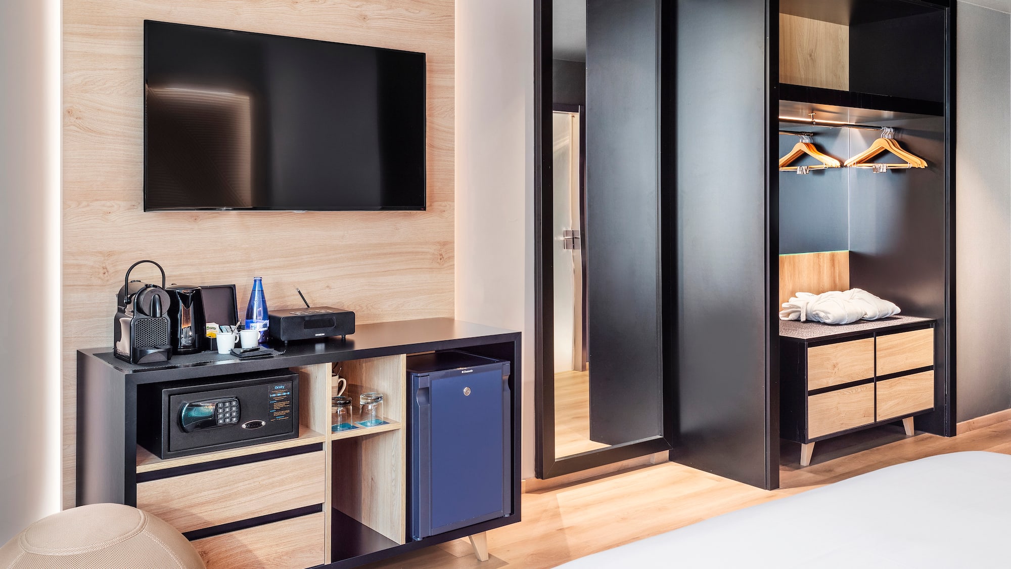 a room with a television and a mirror