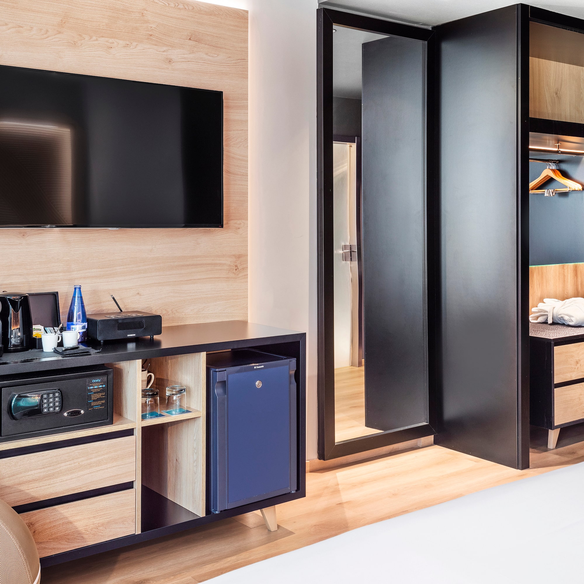 a room with a television and a mirror