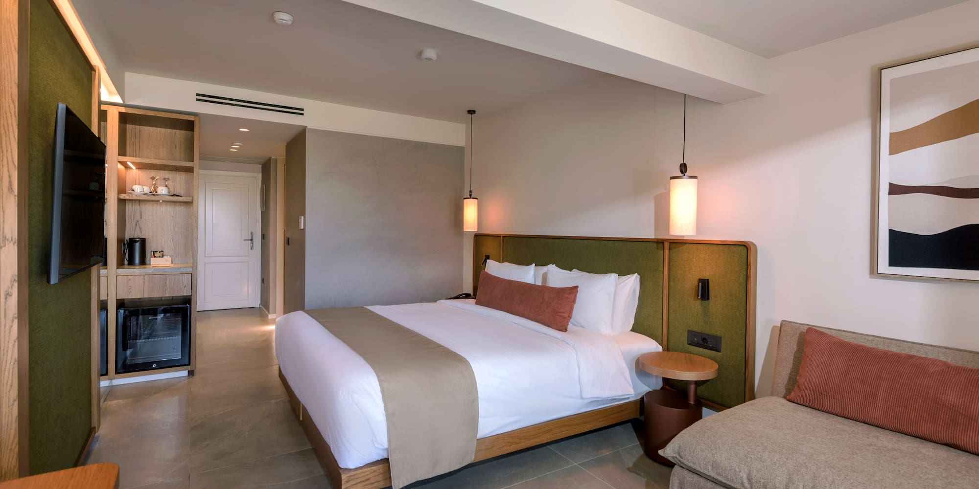 a bedroom with a bed and a television.