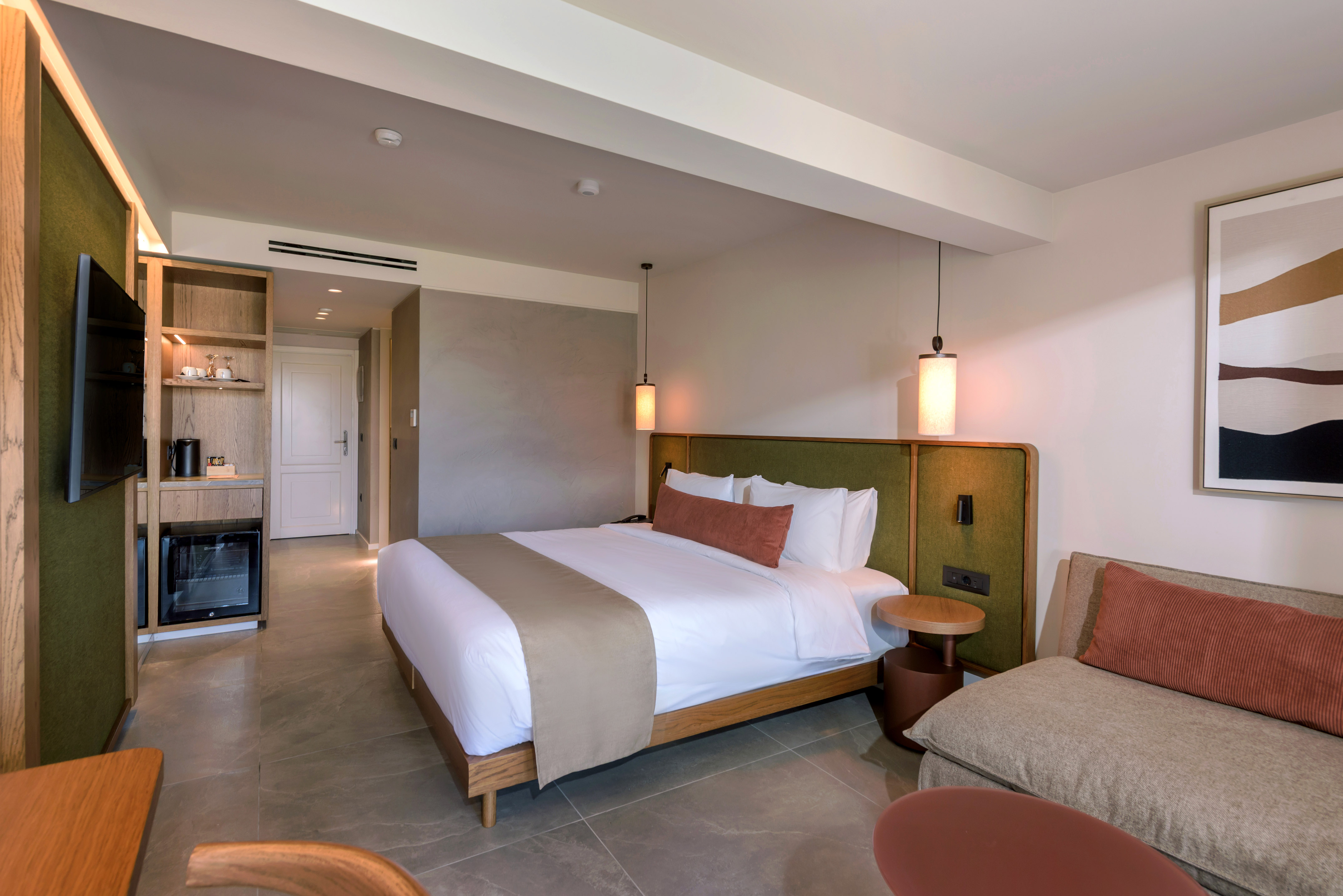 a bedroom with a bed and a television.